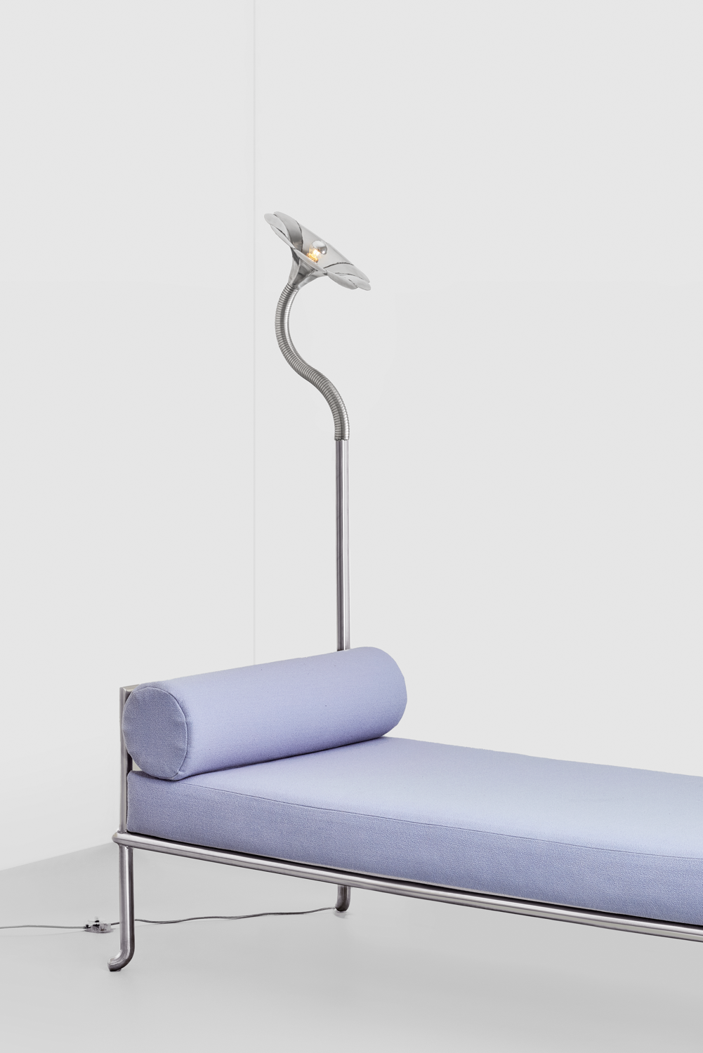 Stainless steel daybed with a lamp by Hannah Kuhlmann at Piece de Resistance gallery in Paris. 