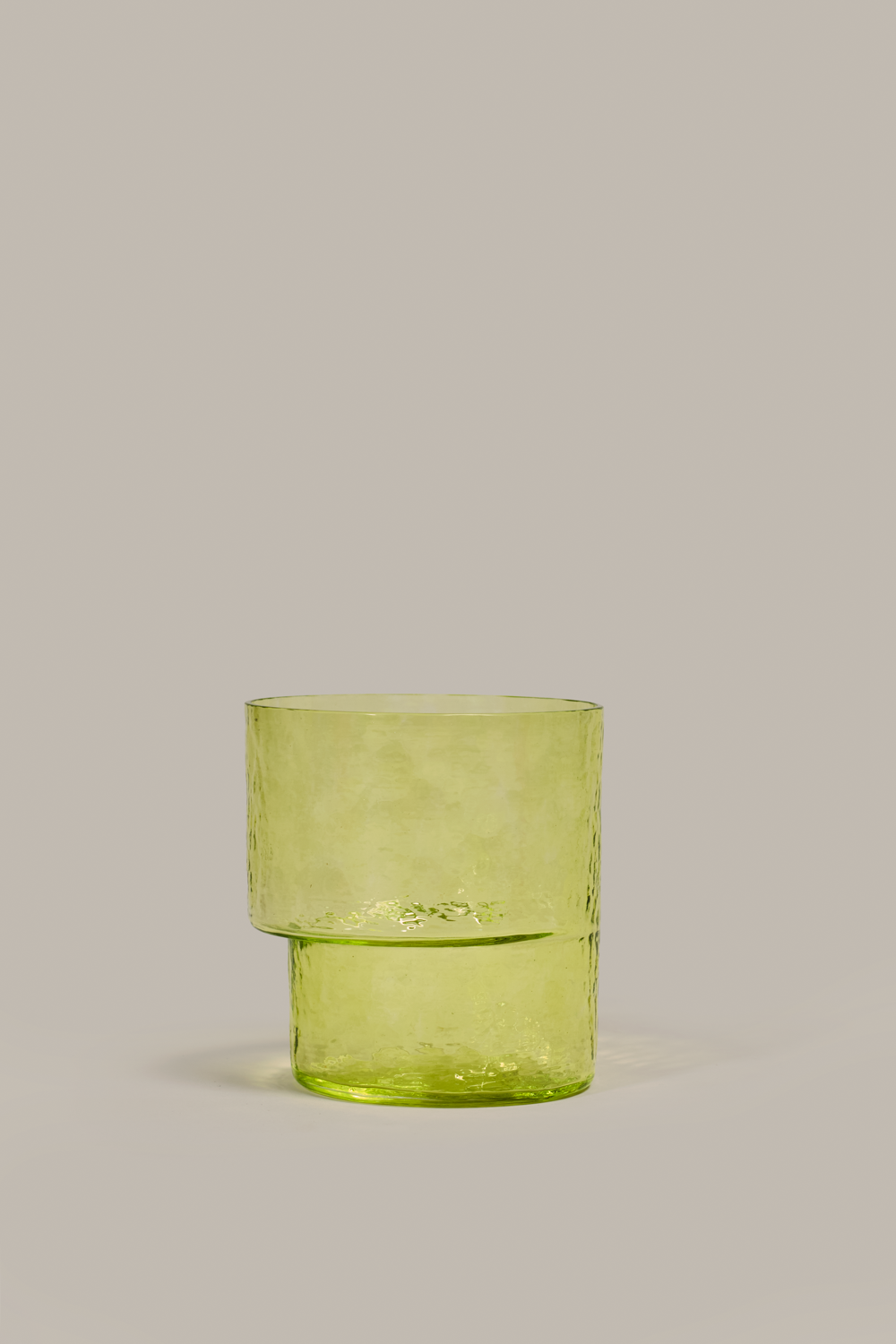 Asymmetrical stackable Pool tumbler in lemon yellow green glass by Cornelius Réer